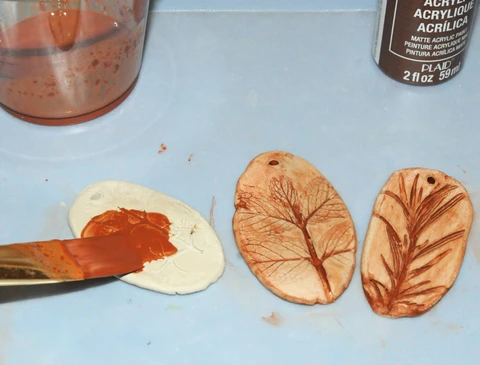 painting and sealing air dry clay pendant